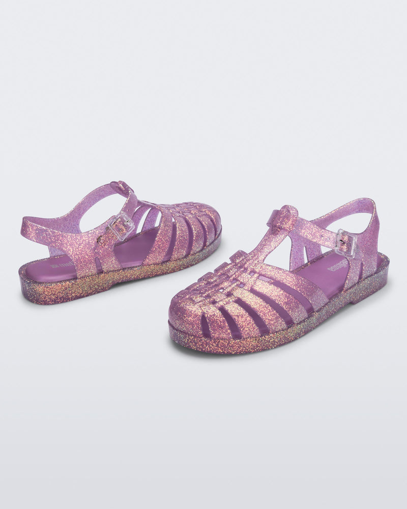 Top and angled view of a pair of glitter lilac Possession sandals
