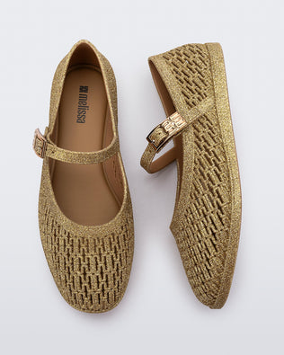 Top and side view of a pair of beige glitter Harper flat with strap