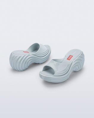 Back and side view of a pair of light blue Platforms + Diesel slides