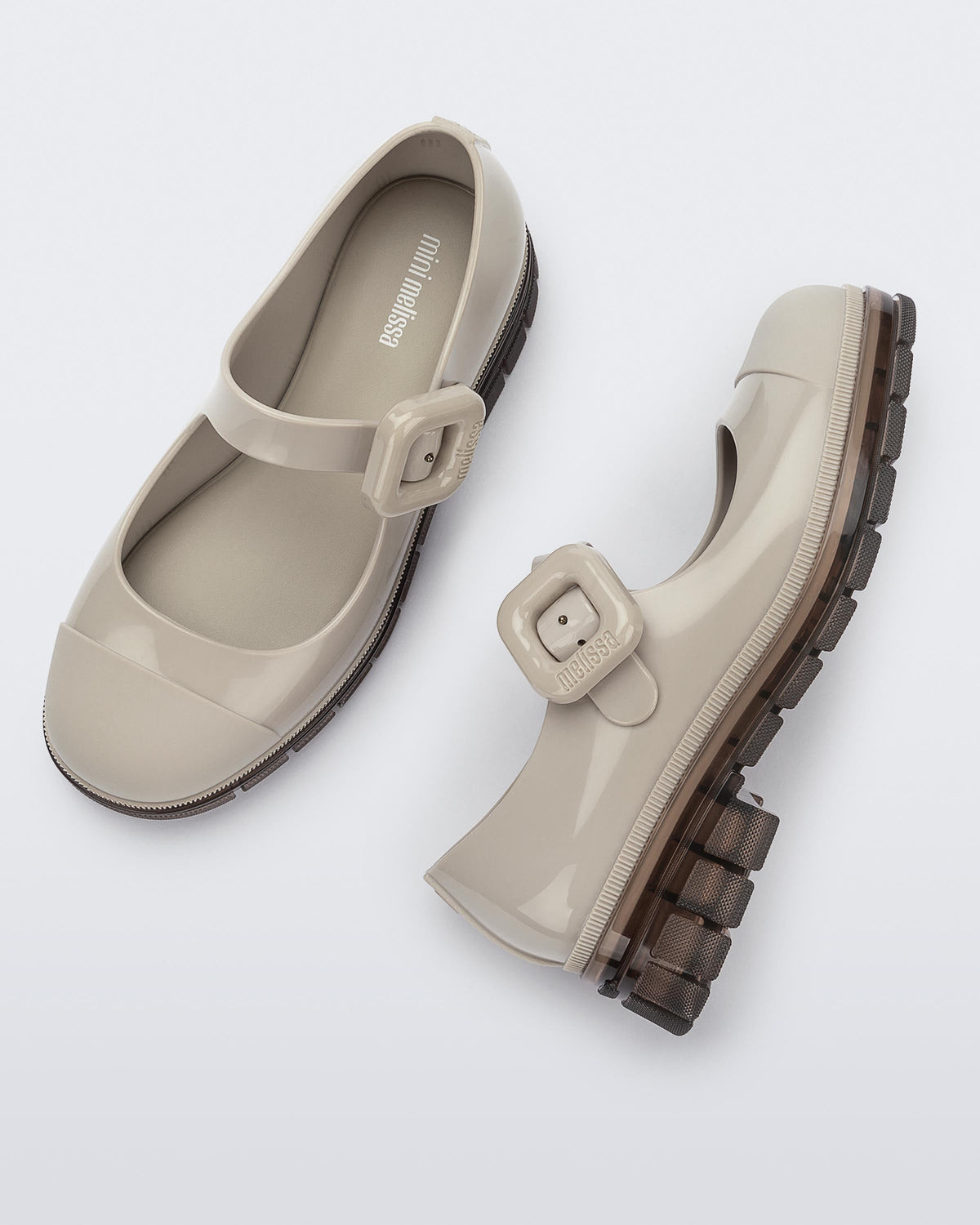 Top and side  view of a pair of beige with brown sole June kids mary janes with matte toe cap