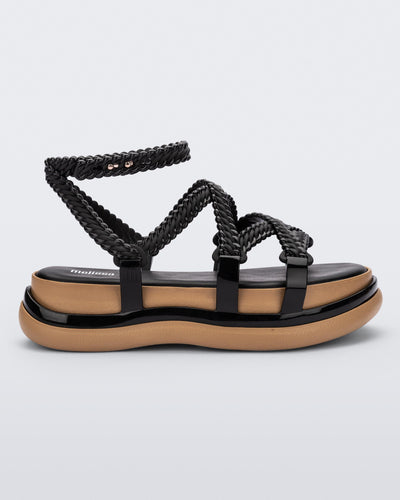 Side view of a black Melissa Buzios platform sandal with multiple textured straps that mimic sisal braids across the front of the shoe as well as an ankle strap