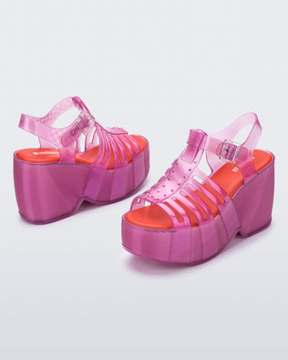 Back and side angled view of a pair of pink Station 79 platform heels with ankle straps