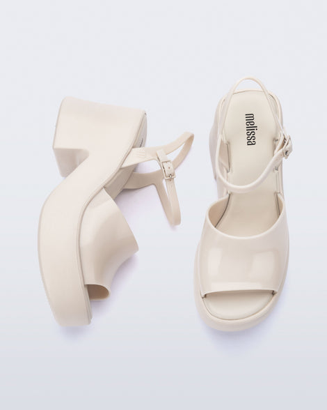 Top and side view of a pair of beige Lina platform heels