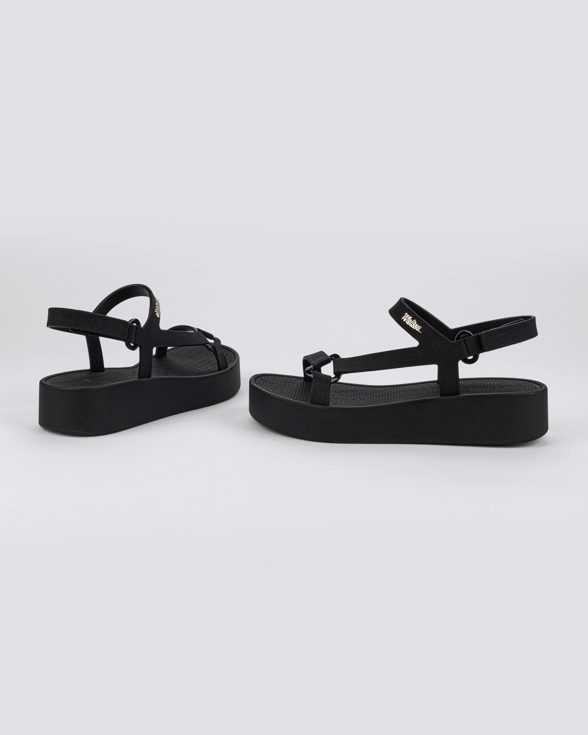 Angled side and back view of a pair of black Sun Downtown Platform sandals