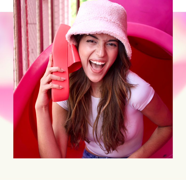 model holding the pink becky up to her face