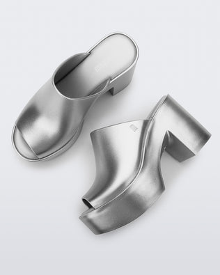 Top and side view of a pair of light silver Mule Hype Platforms