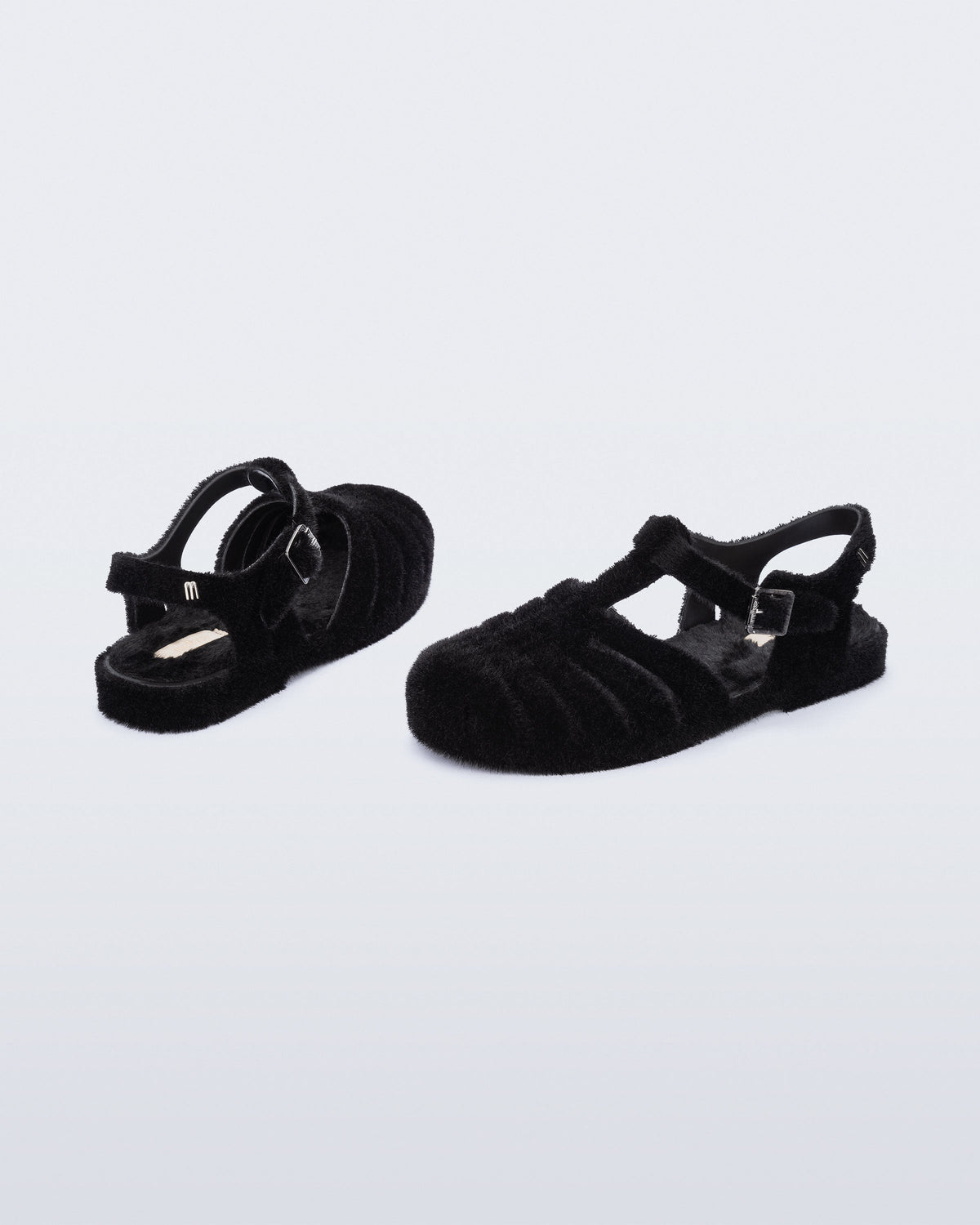 Back and angled view of a pair of black fuzzy Possession Warm fisherman sandals