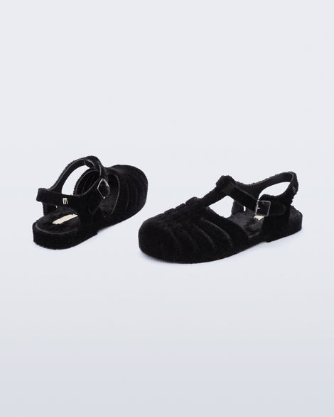 Back and angled view of a pair of black fuzzy Possession Warm fisherman sandals
