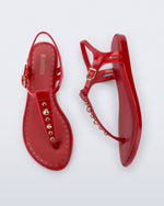 Top and Side view of a pair of red Solar Boho t-strap sandals with ,metallic detailing on the front strap
