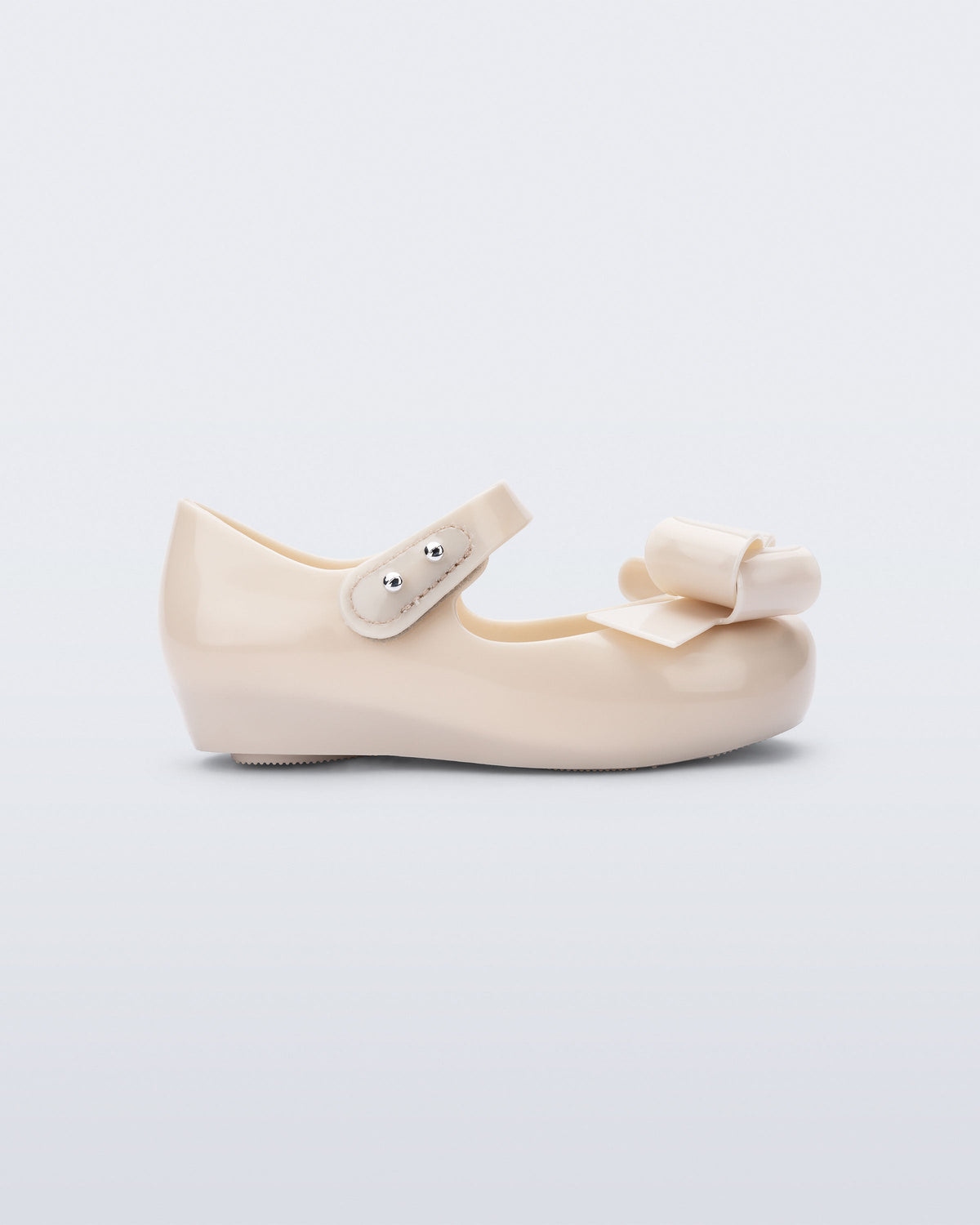 Side view of a beige Ultragirl Classy baby ballerina with beige bow.