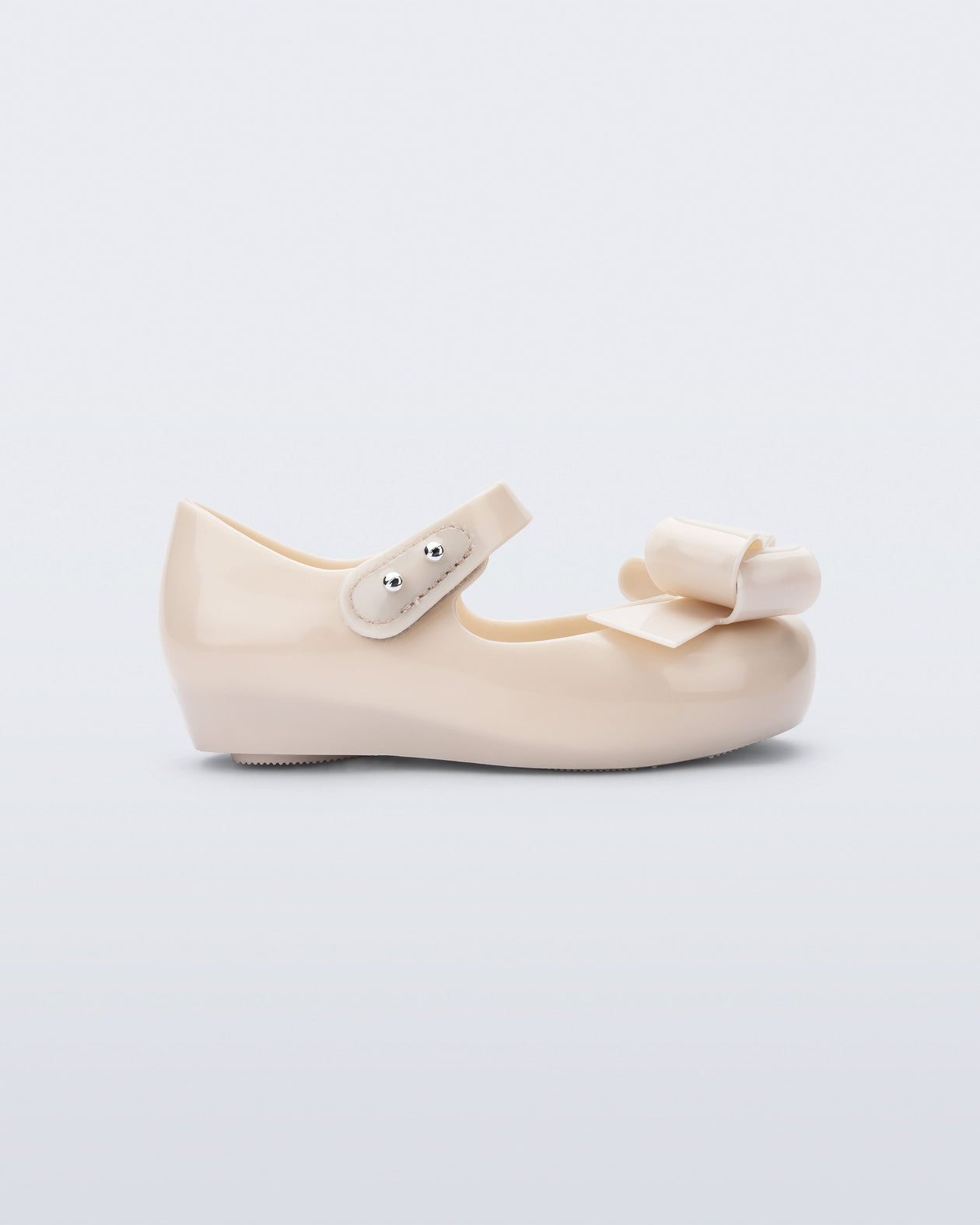 Side view of a beige Ultragirl Classy baby ballerina with beige bow.