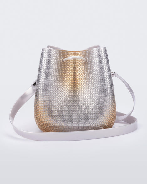 Back view of a silver/gold Lux bucket bag with drawstring and strap