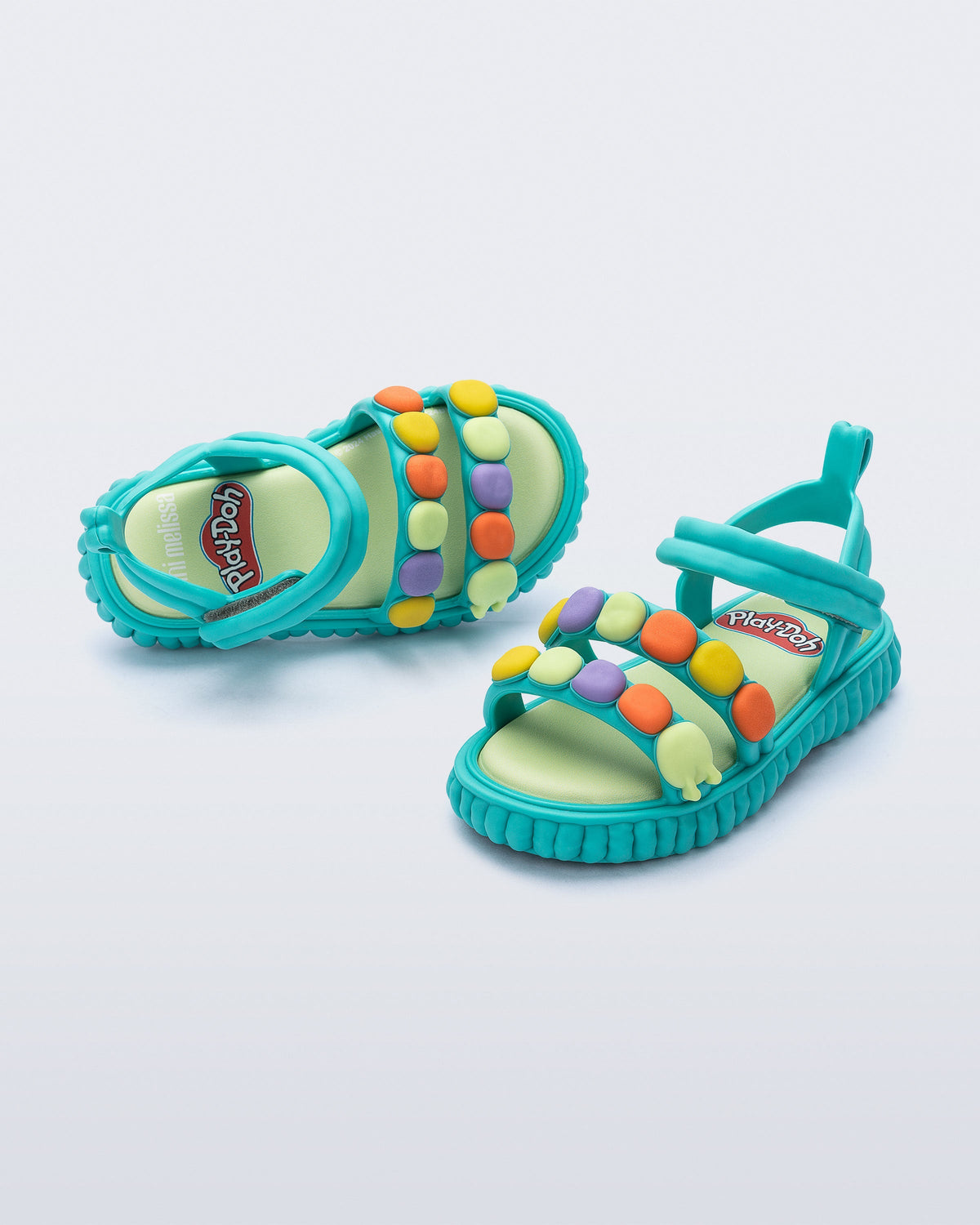 Top and angled view of a pair of blue Create + Play Doh sandal with multicolored dots on the straps