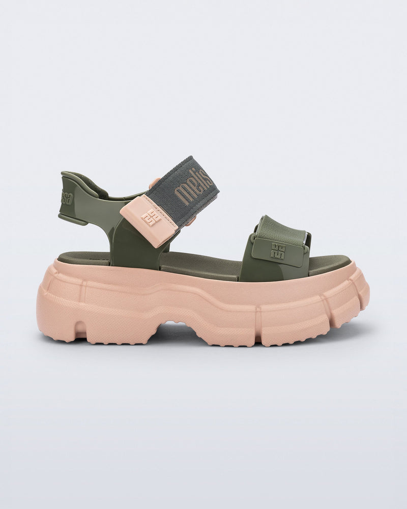 Side view of a green Pulse platform sandal with straps and pink sole