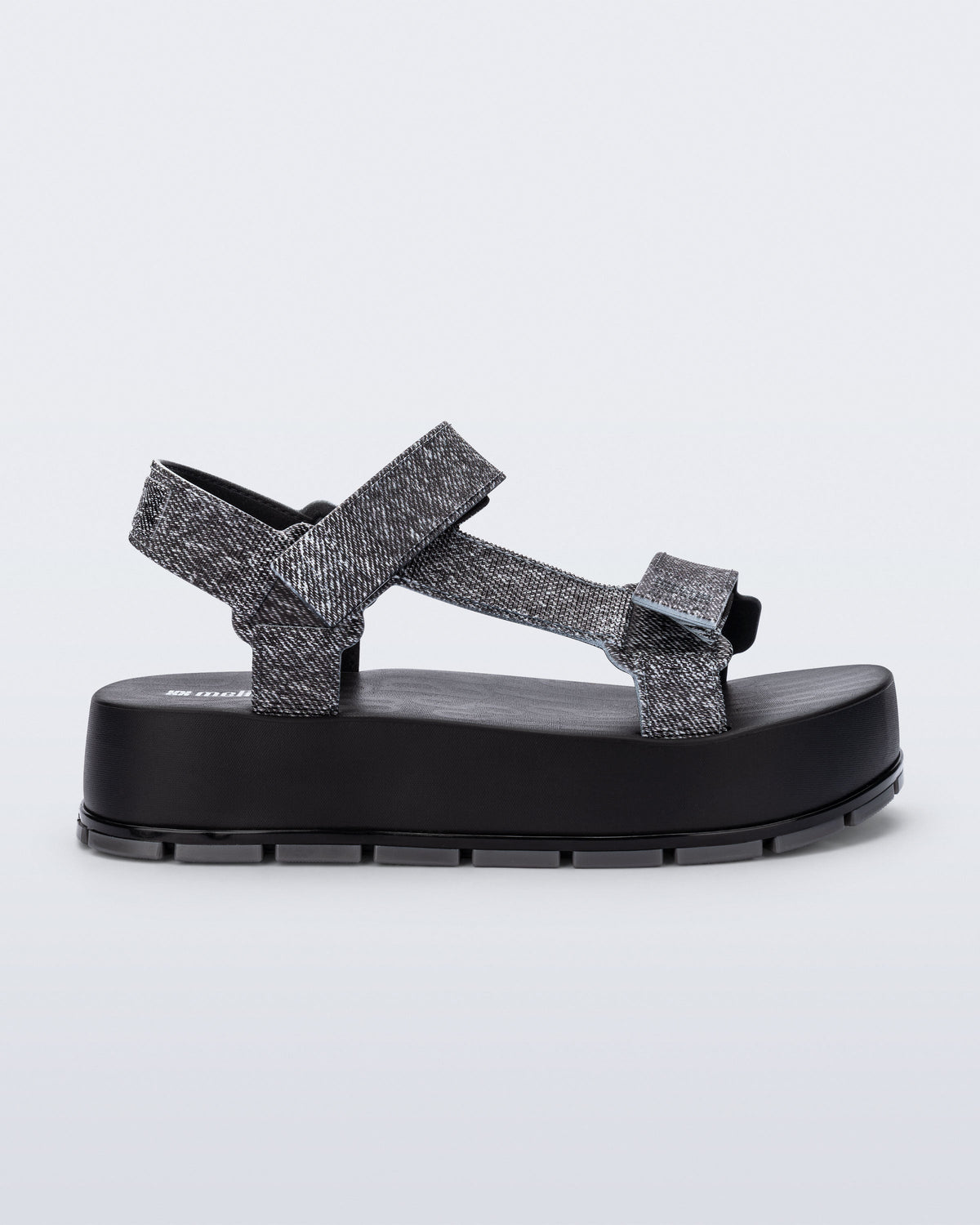 Side view of a black jean Flowing Denim platform