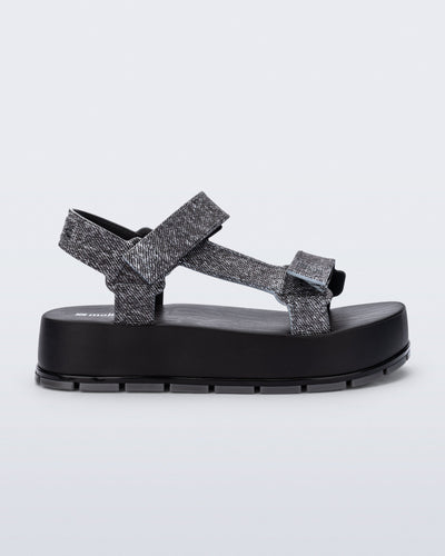 Side view of a black jean Flowing Denim platform