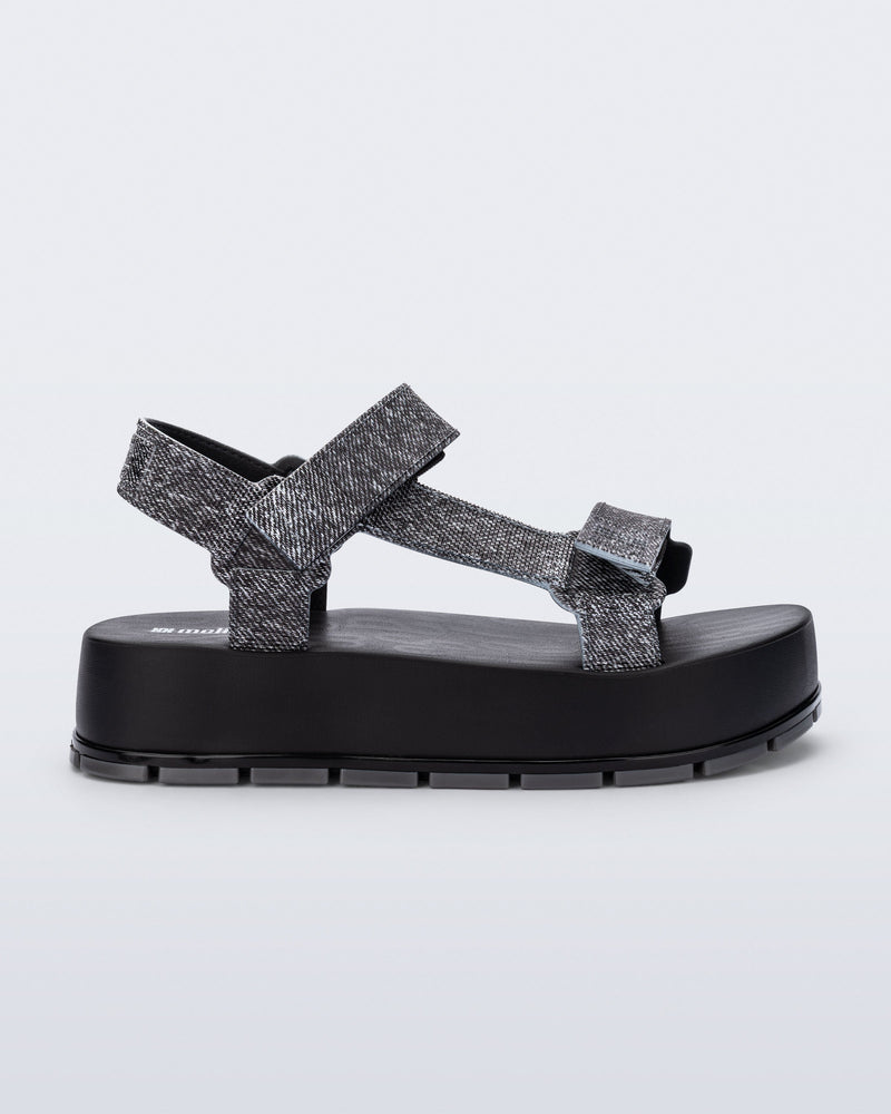 Side view of a black jean Flowing Denim platform