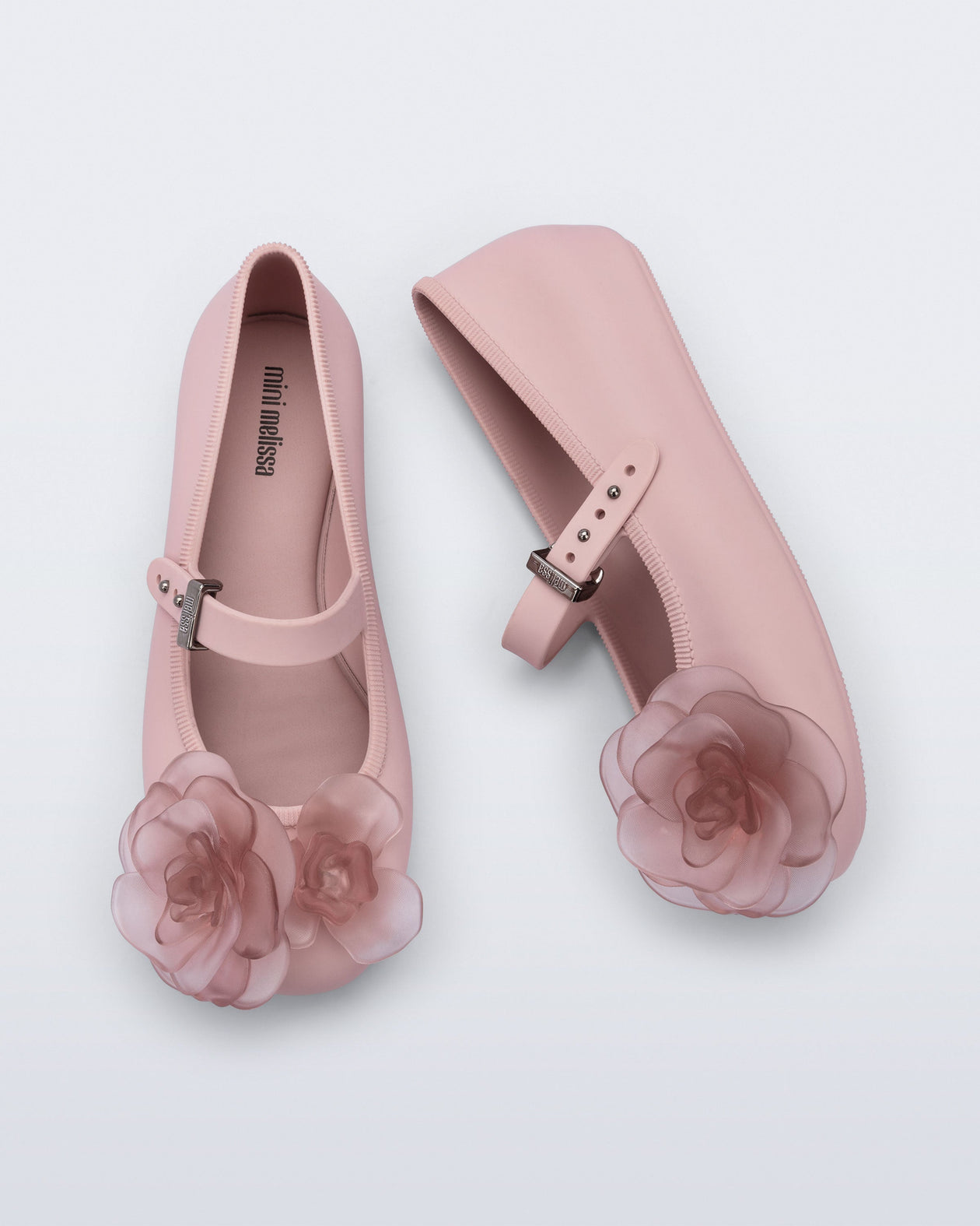 Side and top view of a pair of beige Soft Ballerina Petals kids flats with clear pink flowers