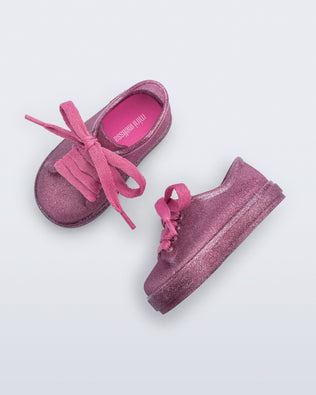 Side and top view of a pair of glitter pink baby Hip Sneakers pink laces