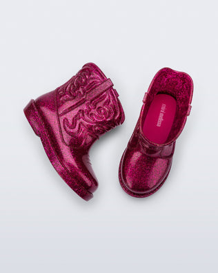 Top and side view of a pair of glitter pink Texas baby boots