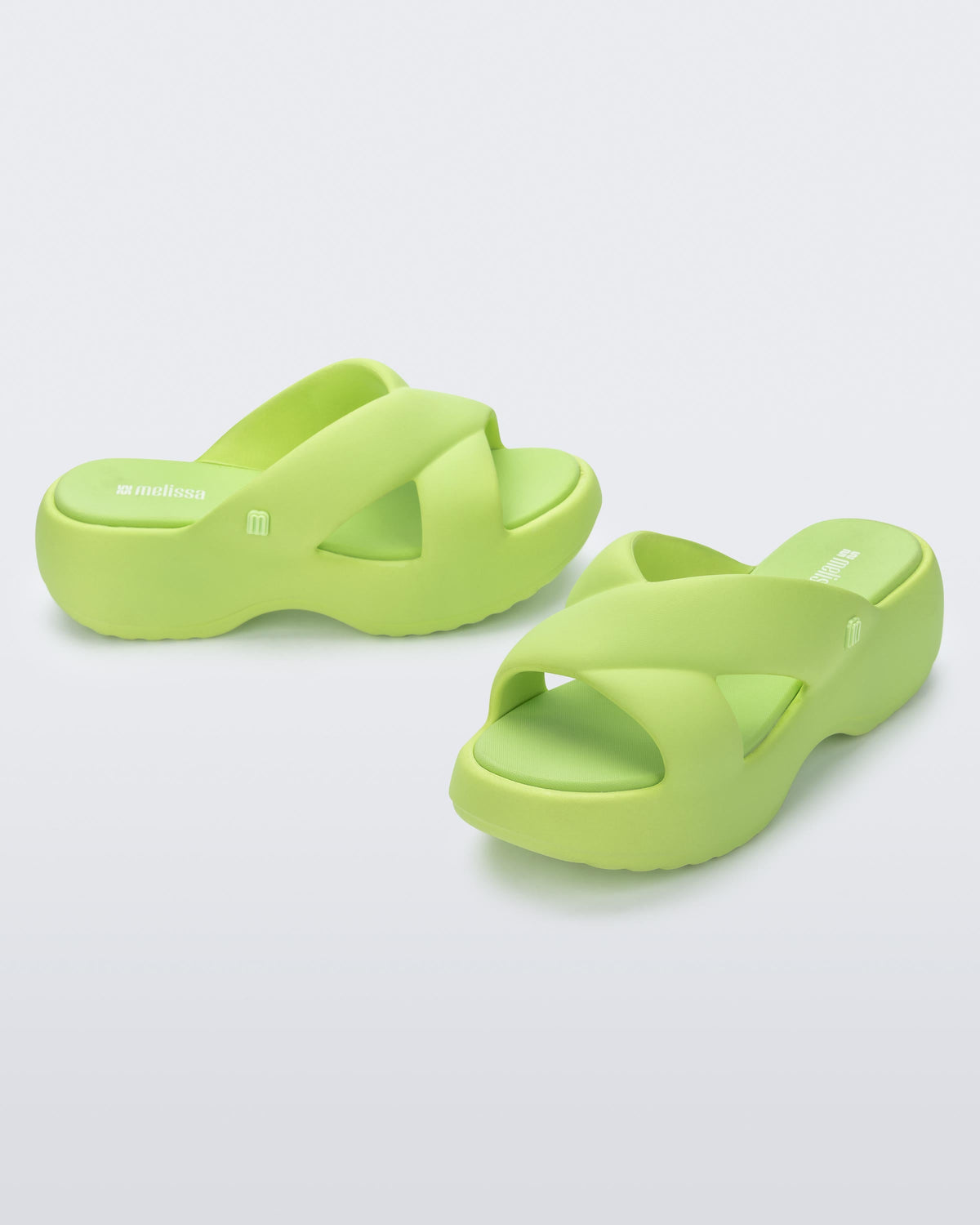 Side and angled view of a pair of green Free Rise platform slide