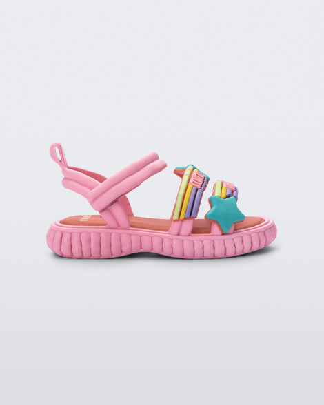 Side view of a pink Create + Play Doh sandal with rainbow and a star straps