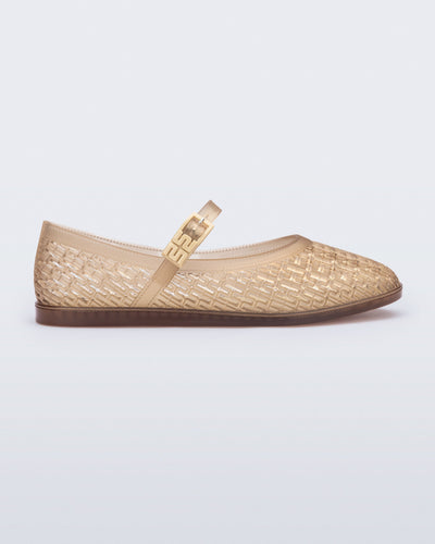 Side view of a clear beige Harper flat with strap