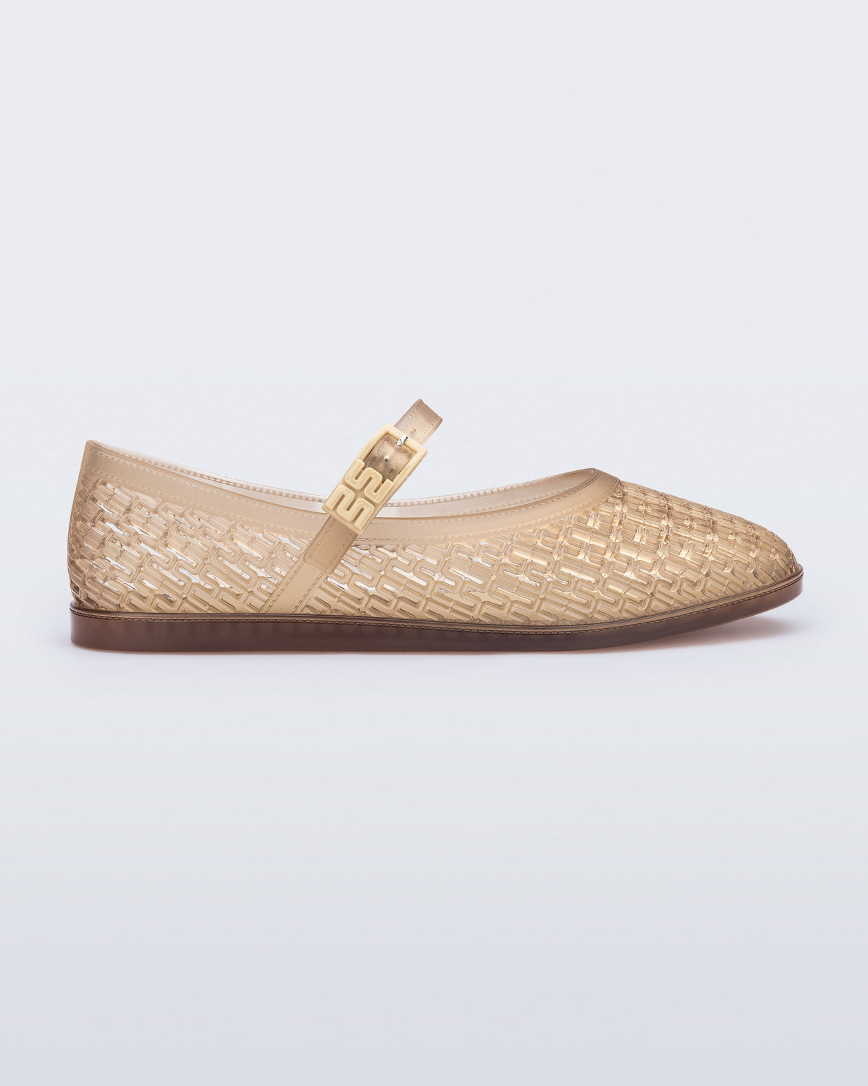 Side view of a clear beige Harper flat with strap