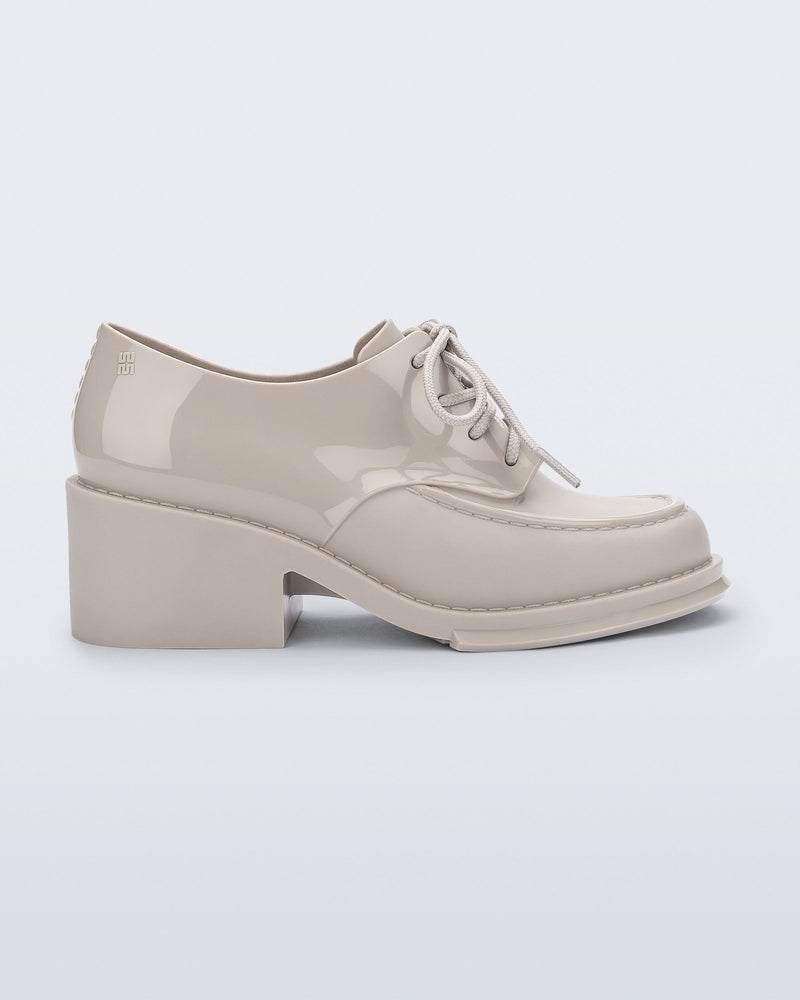 Side view of a beige Tailor loafer with laces