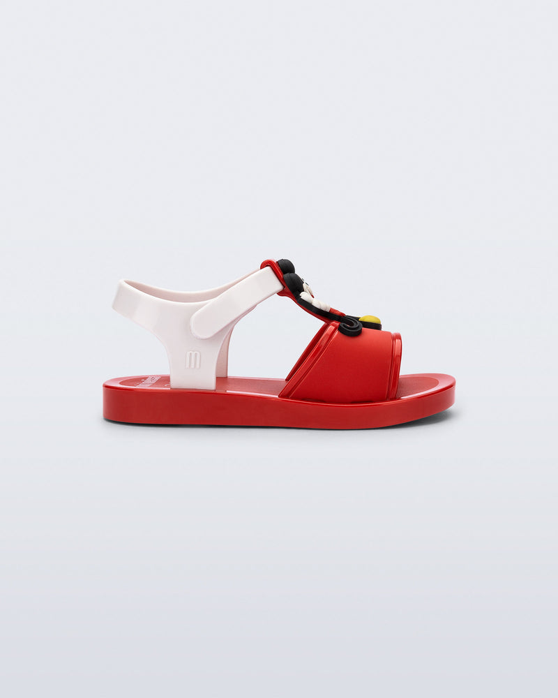 Side view of a red  Play Mickey & Minnie sandals with white straps
