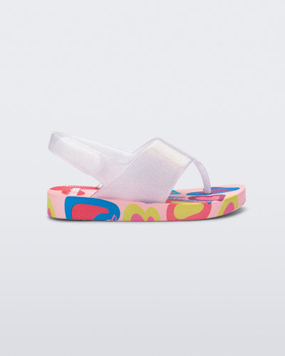 Side view of a pink glitter Shiny baby sandals with multicolor sole