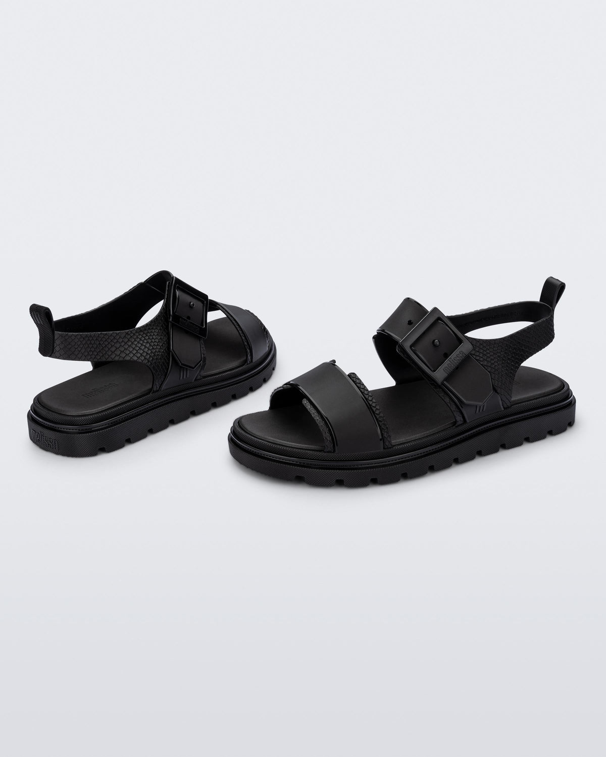 Angled view of a pair of black Connection Papete sandals