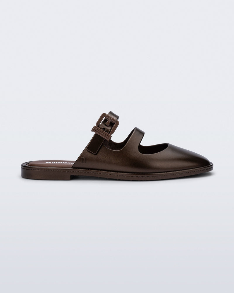 Side view of a bronze Anastasia mule slide with upper straps