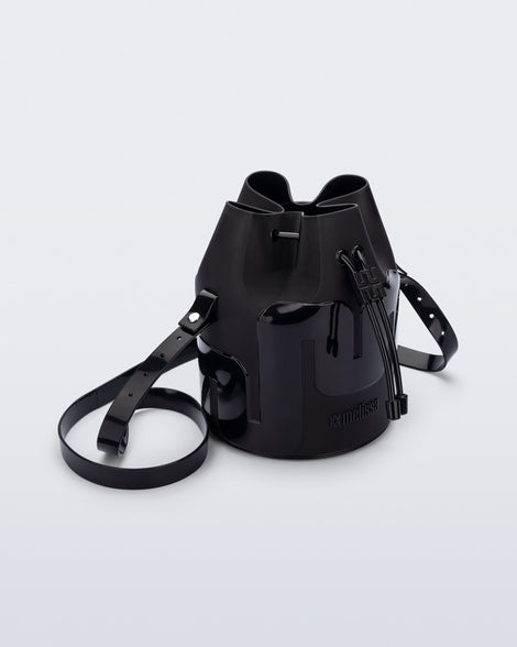 Angled view of a Melissa Station bucket bag in Black. The bag has an adjustable shoulder strap and a drawstring top closure. 