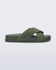 Side view of the Melissa Cozy slide sandals. The slide has two cross straps with Melissa logo embossed onto the straps. The color of the shoe is a dark green. 