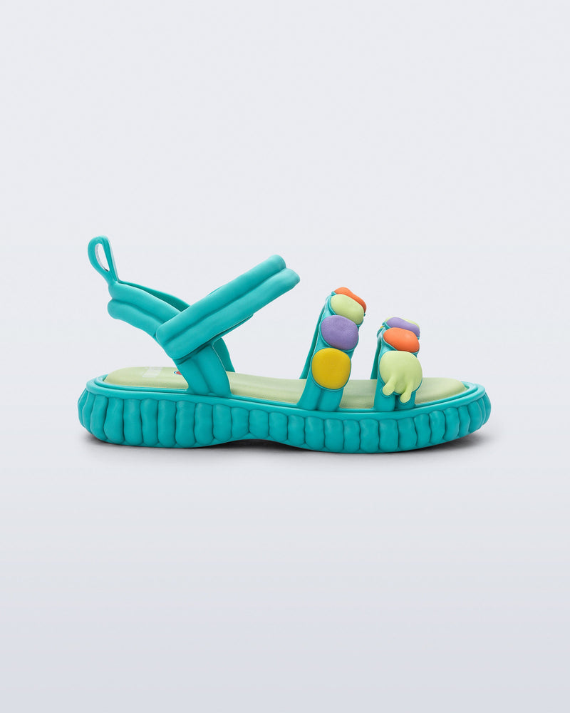 Side view of a blue Create + Play Doh sandal with multi color dots on the straps