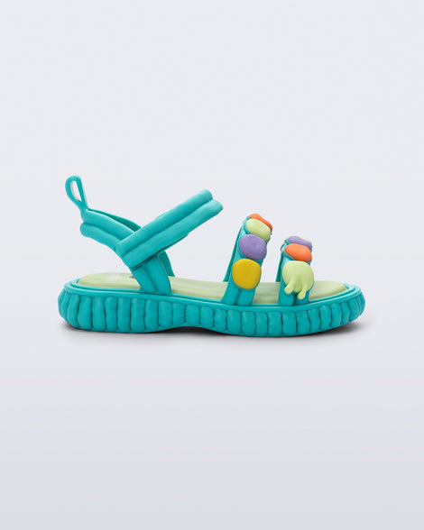 Side view of a blue Create + Play Doh sandal with multi color dots on the straps