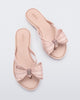 Overhead view of a pair of Melissa slim strap flip flops in glitter pink with bow applique