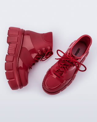 Top and side angled view of a pair of red Rebel Boots with laces