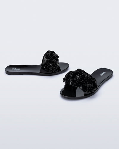 Angled view of a pair of black Babe Springtime slides.
