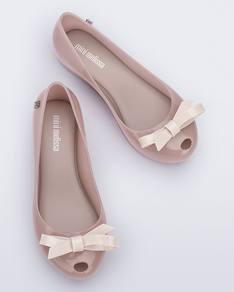 Top view of a pair of pink kids Ultragirl Bow flat