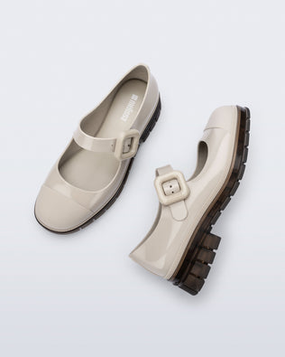 Top and side  view of a pair of beige with brown sole June mary janes with matte toe cap