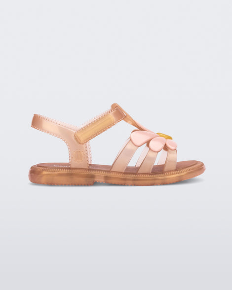 Side view of a pearly brown baby Hip Bloomy sandal with pink  flower