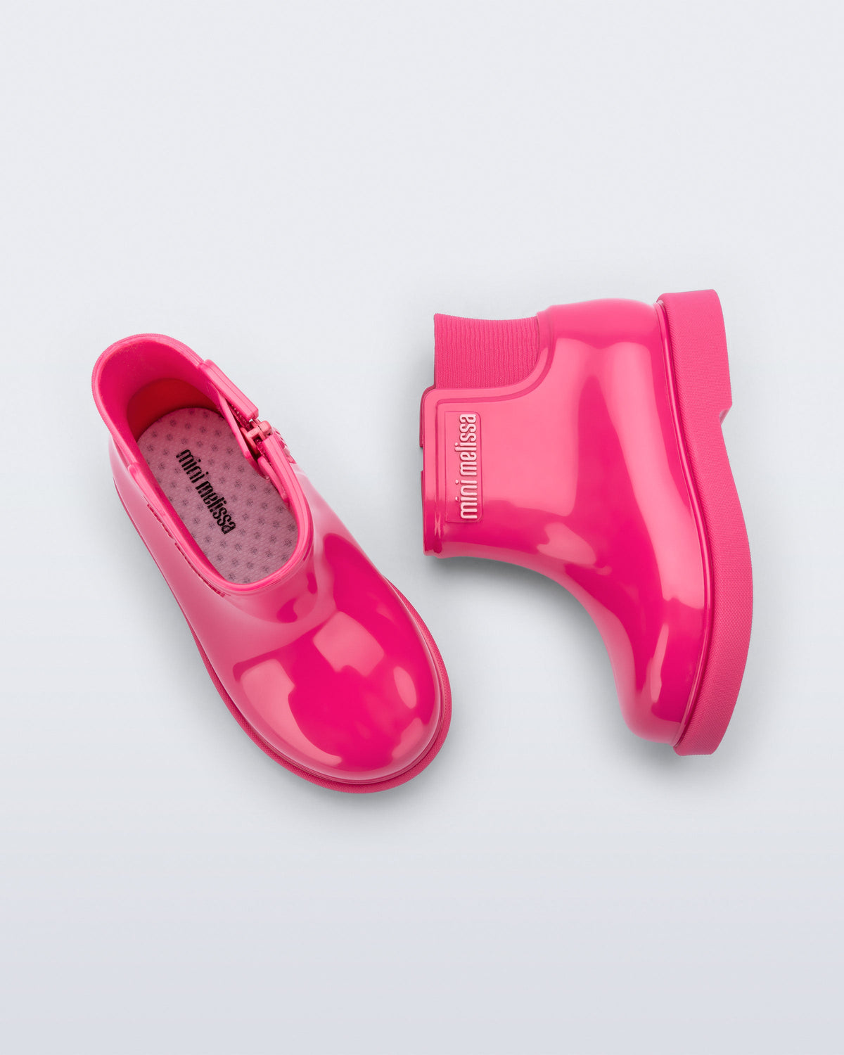 Top and side view of a pair of pink Chelsea II baby boots