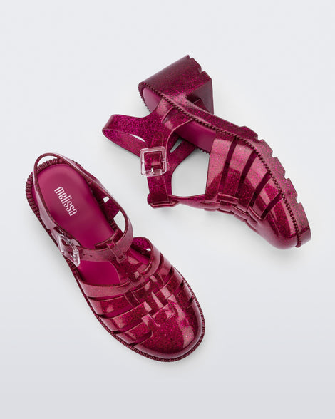 Side and top view of a pair of glitter pink Possession Heel sandals