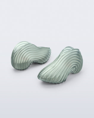 Back and angled view of a transparent green Sneaker + Diesel