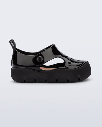 Side view of a black Bowie baby sandal.