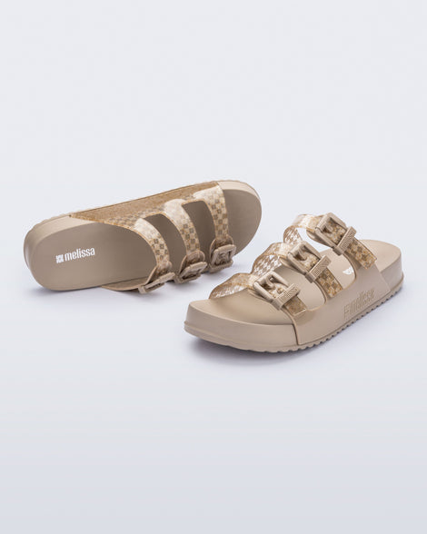 Top and angled view of a pair of beige Cozy Stripes slides