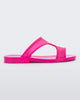 Side view of a transparent neon pink Melissa Bikini Slide with two straps conjoining in the middle.