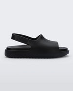 Side view of a matte black Mini Melissa Cloud sandal with a black insole, base and back velcro strap.